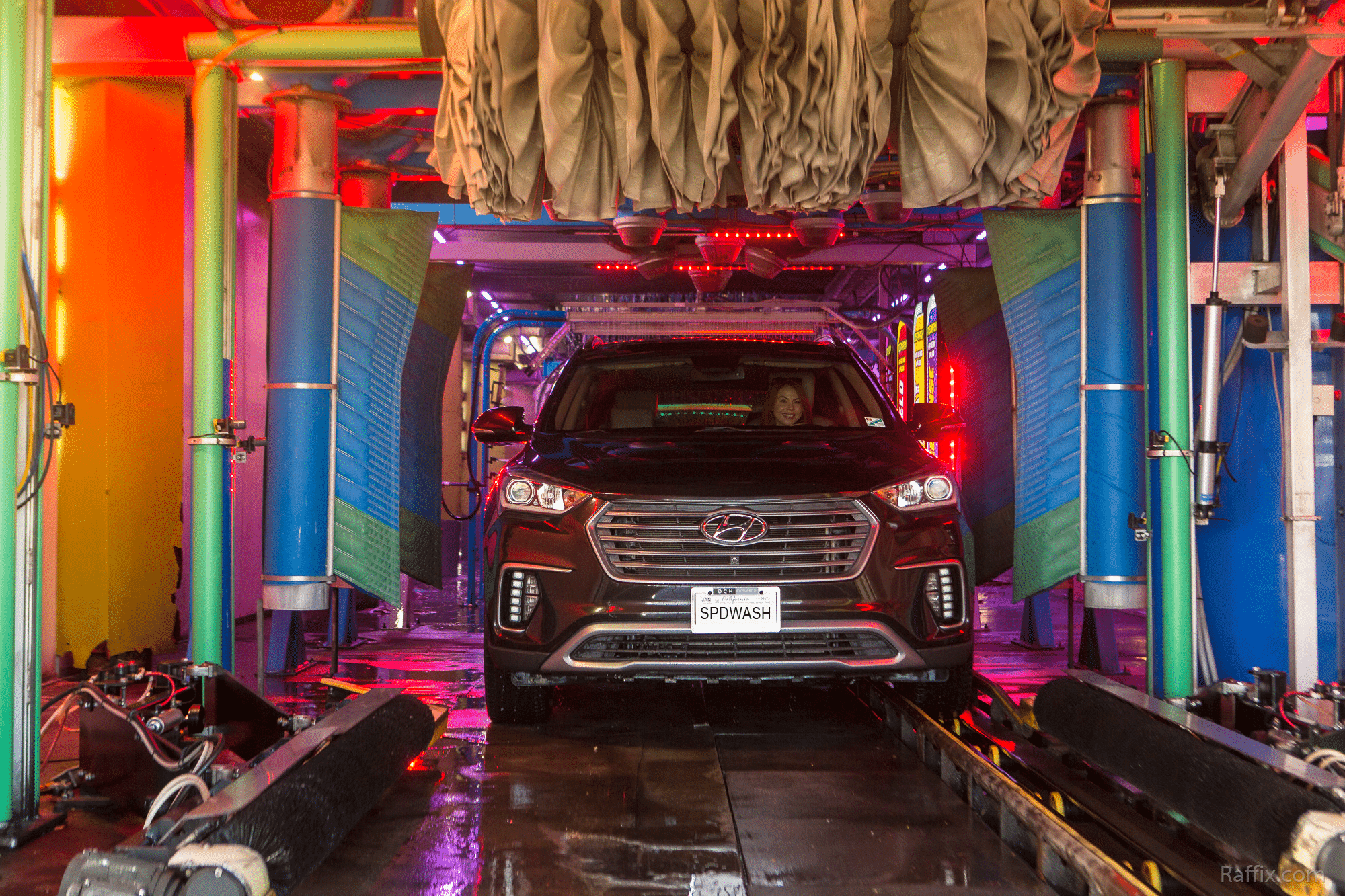 vehicle being washed in an illuminated tunnel